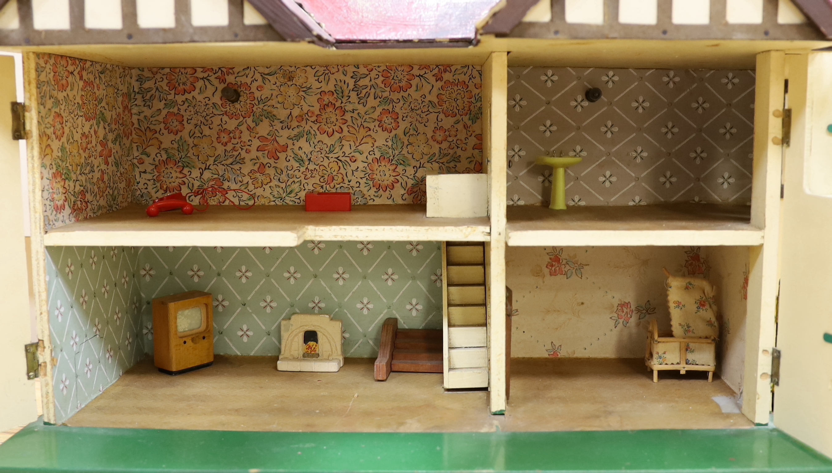 A 1930's Tri-ang doll's house with opening front and a small quantity of furniture